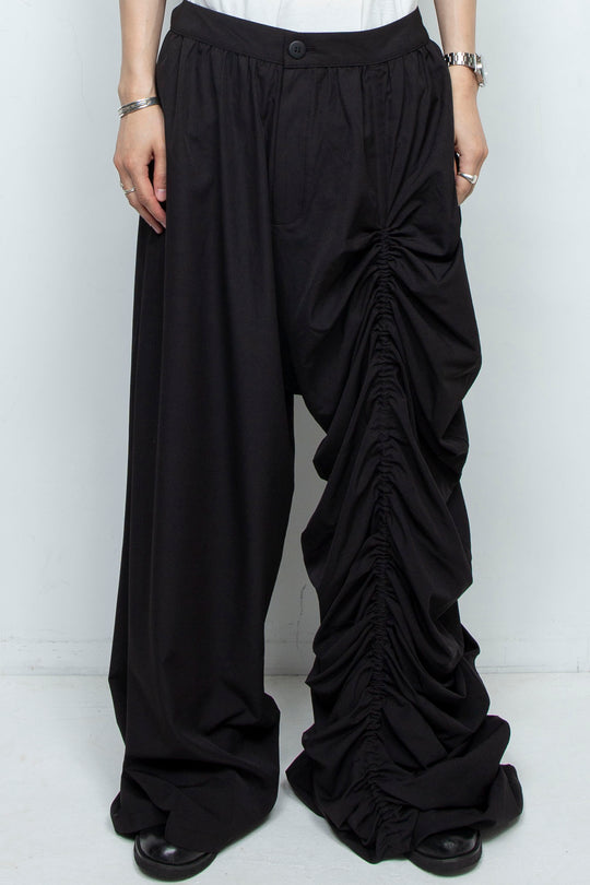 BLACK WIDE-LEG ASYMMETRIC GATHERED PANEL TROUSERS